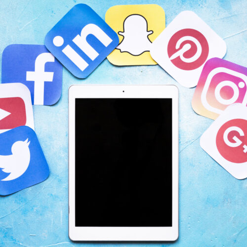 digital-tablet-around-colorful-social-media-icons-painted-blue-background SMM Package A