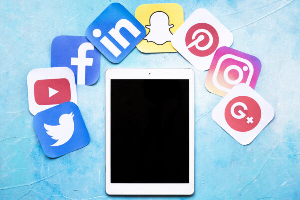 digital-tablet-around-colorful-social-media-icons-painted-blue-background SMM Package A